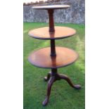 A 19th century mahogany three tier dumb waiter, raised on a tripod base, height 43ins, diameter of