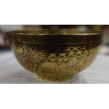 An Eastern design brass bowl, decorated with figures