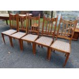 A set of five Edwardian Arts and Crafts style oak dining chairs, with pierced decoration