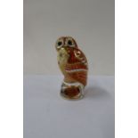 A Royal Worcester candle snuffer, Tawny Owl, together with a Royal Crown Derby Robin paper weight