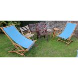 A pair of deck chairs, four folding chairs and two stools