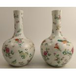 A pair of Chinese famille rose bottle vases, with Yongzheng seal marks, decorated with aster,