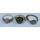 An Antique diamond cluster ring, together with a sapphire and diamond cluster ring and a three stone