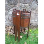 An Arts and Crafts style oak planter, with metal banding, width 12.5ins, height 25ins