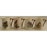 Four Royal Worcester barrel moulded jugs, decorated with a Bullfinch, a Robin, a Kingfisher and a