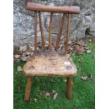 A child’s primitive stick back chair