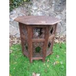 An middle Eastern design octagonal table, with all over intricate carved decoration, width 24ins,