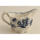 A late 18th/early 19th century moulded cream jug, decorated with blue flowers, height 2.75ins, width