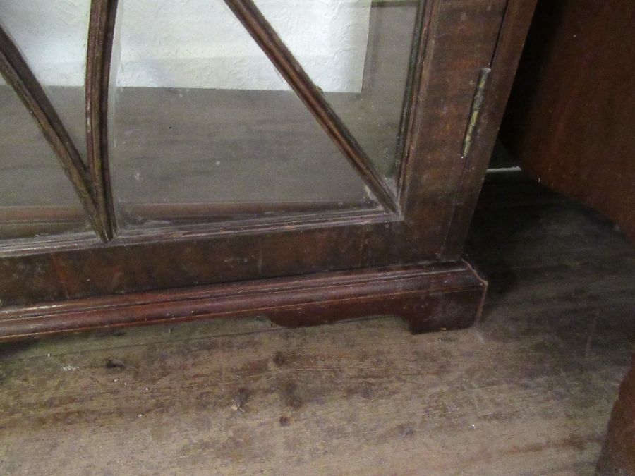 A 19th century narrow bookcase with astragal glazed bars opening to revea l shelves raised on - Image 4 of 4