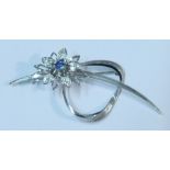 An 18k white gold and floral spray brooch, the flower with central round cut sapphire and three