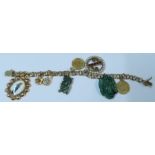 A 14k charm bracelet, suspending a tenth of a Kruggerand, a carved jadeite fish charm and six