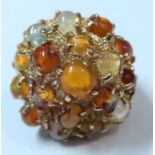 A 14k dress ring with numerous fire opals and others