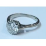 An 18ct white gold solitaire diamond ring, claw set with round brilliant cut diamond of
