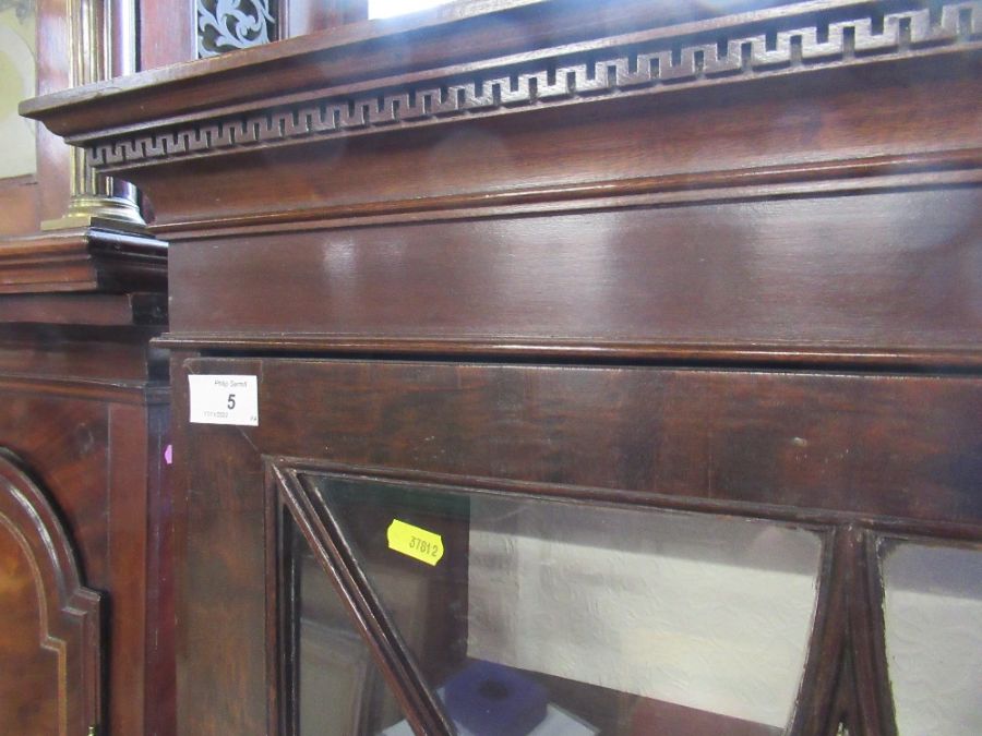 A 19th century narrow bookcase with astragal glazed bars opening to revea l shelves raised on - Image 2 of 4