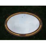 An oval gilt framed mirror, width 41ins
