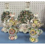 A pair of 19th century porcelain candlesticks, decorated with rabbits and encrusted with flowers,
