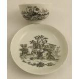 A Worcester tea bowl and saucer decorated with a black transfer print of the Tea Party