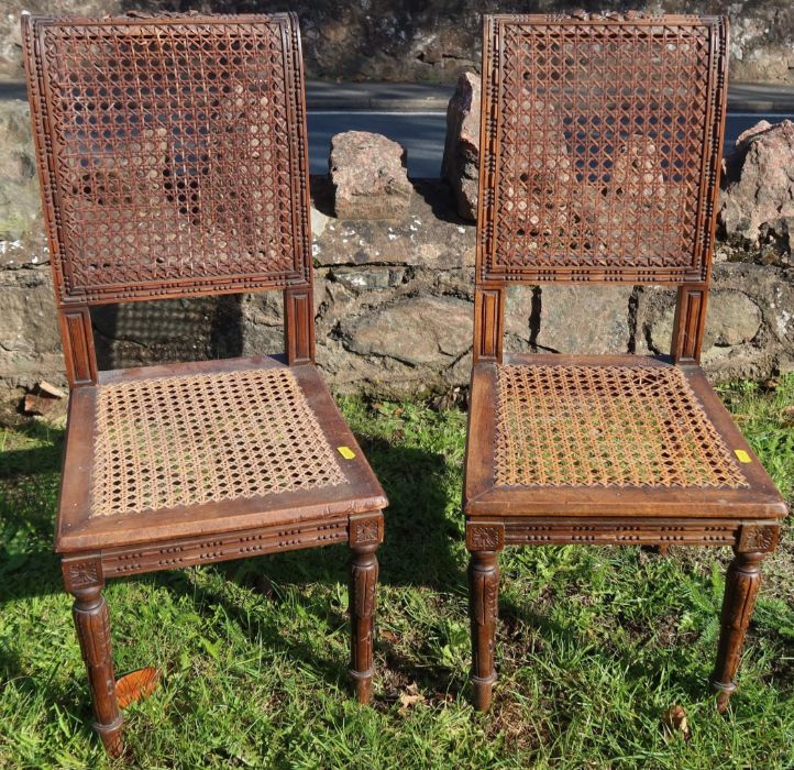 A pair of children's carved beech chairs, with cane seats and backs