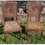 A pair of children's carved beech chairs, with cane seats and backs