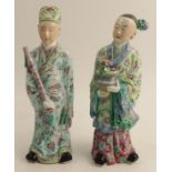 A pair of late 19th century/early 20th century Chinese porcelain figures, modelled as dignitaries in