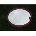 An oval mahogany framed mirror, width 44ins