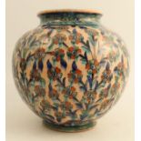 An early 20th century Persian style Safavid vase decorated with flowers on a salmon pink ground