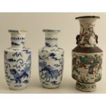 A pair of Chinese blue and white vases, decorated with mythical beasts, with four character marks to