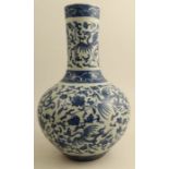 A Chinese blue and white bottle vase decorated with a phoenix and flowers