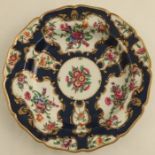 A Worcester scale blue plate decorated with flowers