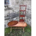 An Edwardian cake stand, mahogany oval tray and a coffee table