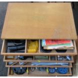 Meccano Outfit No.10. a wooden four drawer cabinet containing Meccano pieces and booklets,