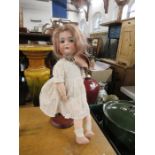 A bisque headed doll, stamped BSW