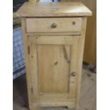 A pine bedside cabinet, fitted with a drawer over a cupboard, 17ins x 5ins, height 31.5ins