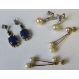 A pair of 14k white gold drop earrings each set sapphire cluster suspending a marquise-cut