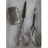 A silver vesta case, together with a pair of silvers and a manicure tool