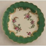 A Worcester plate, from the Marchioness of Huntley service, painted with flowers on an apple green