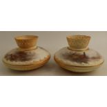 A pair of Royal Worcester blush ivory vases, with pierced necks, the squat body painted with