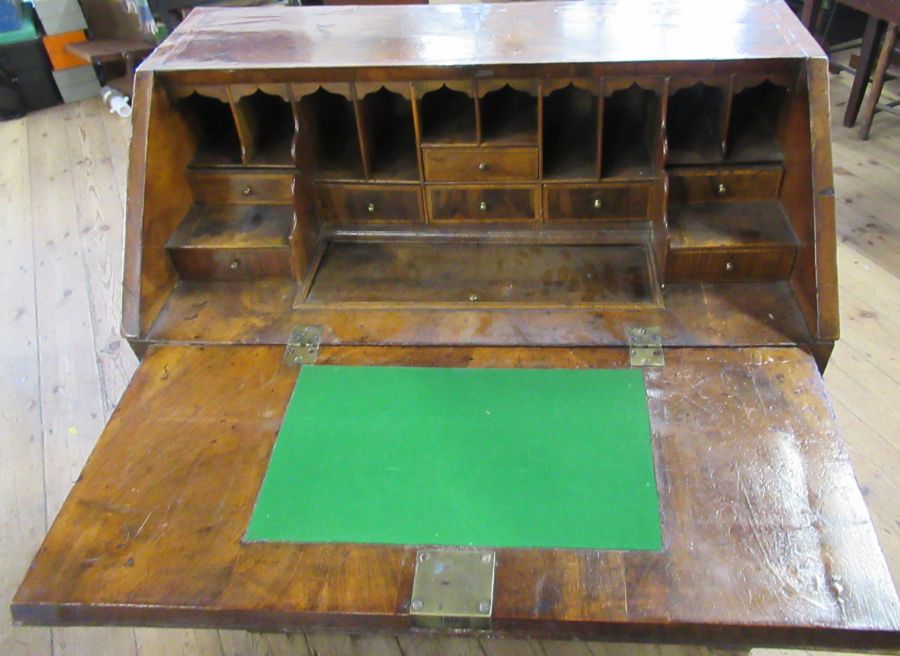 An Antique walnut bureau, with feather banding, the fall flap revealing pigeon holes and drawers - Image 2 of 3