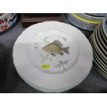 A collection of ironstone plates decorated with fish, together with another plate and turkey dish