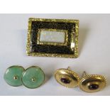 A Victorian rectangular brooch, set with an opal, to a gilt and black frame, 1.25ins x 1ins,