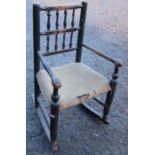 A child's spindle back open arm rocking chair