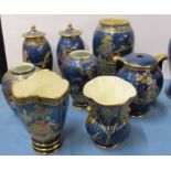 Five Carlton Ware vases, together with three Crown Devon vases, all decorated with a blue lustre