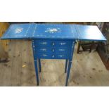 A painted sidetable, fitted with two drop flaps and four drawers