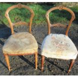 A pair of Howard & Son walnut balloon back chairs, with carved decoration