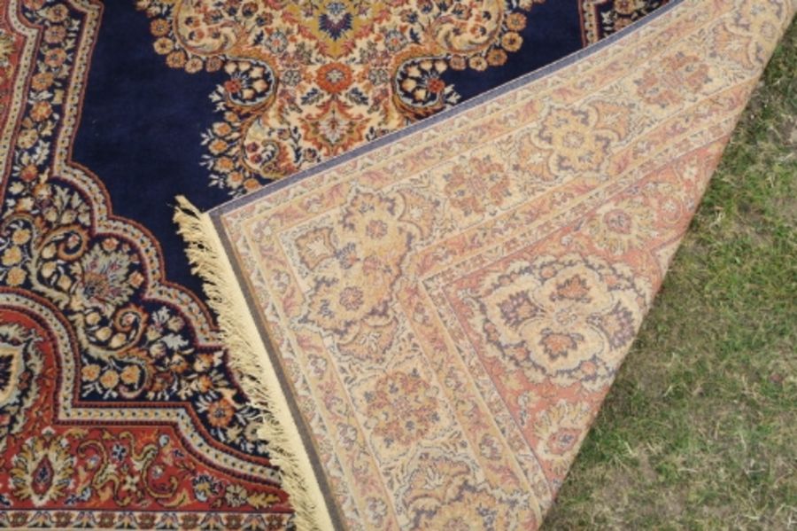 A modern Eastern design rug, the blue ground decorated with a central stylised medallion, 135ins x - Image 2 of 3