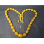 A Faux Amber Bead Necklace 74.5cm Long, Largest Bead 28x22.5mm (109g)