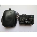 A Rollei 35S Camera In Original Leather Case