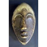 A West African Gabon Carved and Painted Light Wood Spirit Mask, 31cm