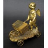 A 19th Century Gilt Metal Figurine of Cupid pushing a luggage barrow with hinged lid and resting