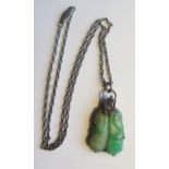 A Chinese Carved Jadeite Pendant in an unmarked white metal and rose cut diamond mount and on a